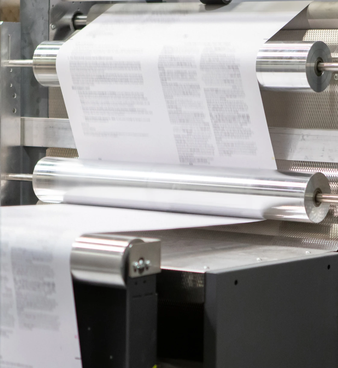 Paper rolling through an industrial printing machine